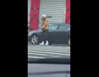 Man walk on street log on shoulder