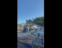 Woman black dress twerk on hill beach