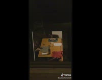 Guy in neighboring apartment sit at dining table with floating fork