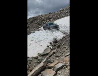 Truck tries to drive over snow 
