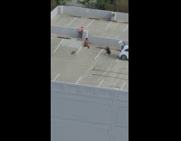 Woman bikini squat pose rooftop parking lot