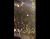 Man sits on top of statue 