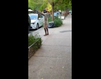 Man barefoot jamming to michael jackson on street
