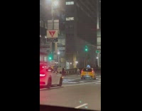 Woman white top poses in the middle of the crosswalk