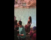 Girl poses in front of fountain