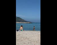 Woman brown bikini walk from the beach to the camera