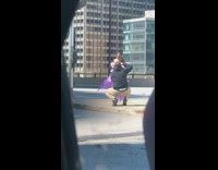 Woman purple frilly long gown street buildings