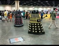 Two robot towers hover in a convention