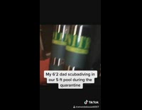 Dad scuba dives in swimming pool