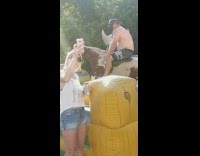 Shirtless man ride mechanical bull vader mask
