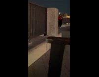 Man red jersey jacket dances at park