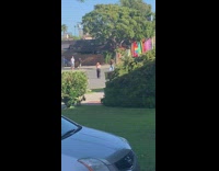 Girl leans back middle of road neighborhood 