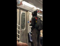 Man punches blue ball hanging on subway