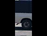 White shirt guy rollerblades photographs friend sidewalk