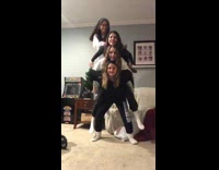 Three girls try to piggyback on one girl 