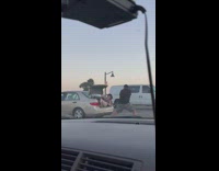 Woman in violet top lie down on the car trunk