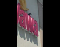 People staring at black crow on top of Wawa sign