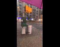 Woman on street shows surroundings rain storm