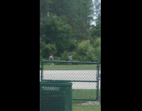 Girl hold brown box spin green fence