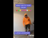 Orange sweater black shorts guy dances indoors 