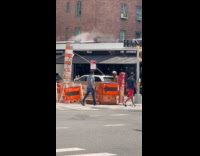 Man with long stick near pipe steam