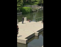 Collab IITW - Woman brown hat bend over headstand pond