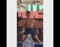 Guy dresses up as Aang from the Avatar blue arrow tattoos, does bottle cap challenge, waterbends water out of bottle