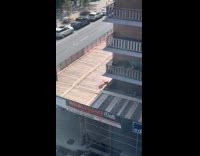 Woman in bikini sunbathe on building roof