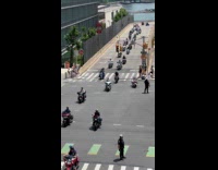 Group of bikers parading on street