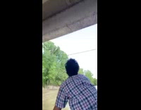 Guy throws catches shotguns beer over bridge