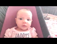 Baby excited and says hello to doll