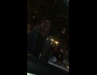 Guy standing by car sings random songs 