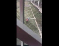 Man red top rap video shoot airport park