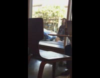 Girl dancing outside of restaurant glass window