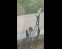 Girls black sweater selfie lamp pole garden