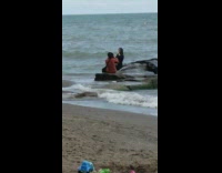 Collab IITW - Pregnant woman black dress sit rock beach