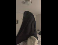 Man put cover on the duvet while woman helps at the bed