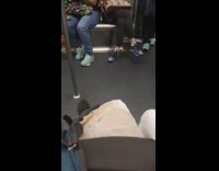 Woman clips her fingernails on subway train
