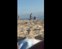 Man behind woman in bikini takes picture