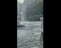 Guy and living statue in water fountain 