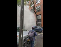 Firefighters try to stop water shooting out of ground 