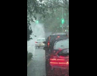 Water shoots out from ground during rain 