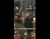 Girls pose on snowy planter for photo