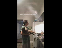 Girl pretending to cook holding cat 