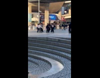 Group dance video shoot near park fountain