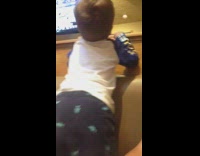 Little boy jumps on booth seat and shakes his butt