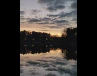 Lake reflects the sunset behind the clouds in the sky Part 1