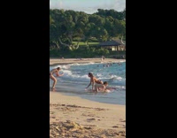 Woman crawl beach gets hit by waves