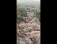 Woman pole dance on rock mountain cliff