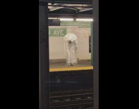 Person waits for subway while wearing jellyfish costume 
